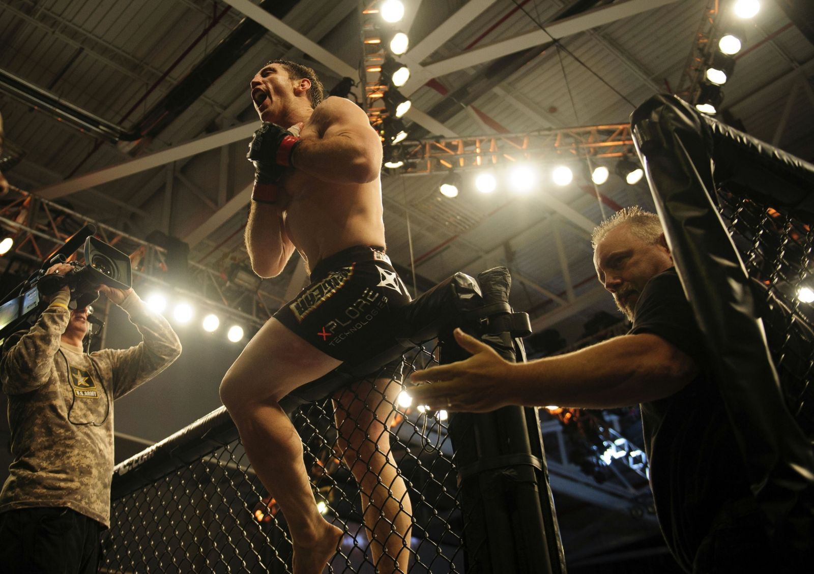 tim kennedy celebrates on cage after knocking out rafael natal
