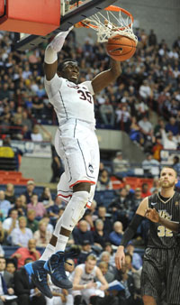 Connecticut's Amida  Brimah (35) dunks a basket during the second half of an NCAA college basketball game against Central Florida Saturday, Jan. 11, 2014, in Storrs, Conn.