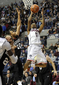 Connecticut Huskies guard Ryan Boatright (11) takes a shot as Harvard Crimson guard Brandyn Curry (10) defends during the first half at Gampel Pavilion in Storrs Wednesday night.