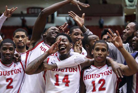  Members of the Houston Cougars celebrate after defeating the Connecticut Huskies 75-71 at Hofheinz Pavilion. 