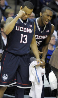  UConn's Shabazz Napier, left, and Lasan Kromah react on the bench during the second half. 