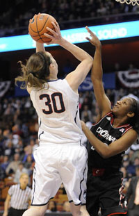  UConn forward Breanna Stewart draws the foul from Cincinnati guard Jasmine Whitfield as she drives to the basket. 