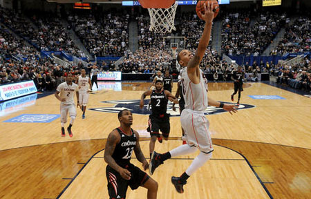  Connecticut guard Shabazz Napier glides in for two of his game high 18 points against Sean Kilpatrick and the Cincinnati Bearcats. 