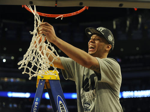 UConn's Shabazz Napier cuts down the net after defeating Michigan State in the NCAA East Regional final Sunday at Madison Square Garden.