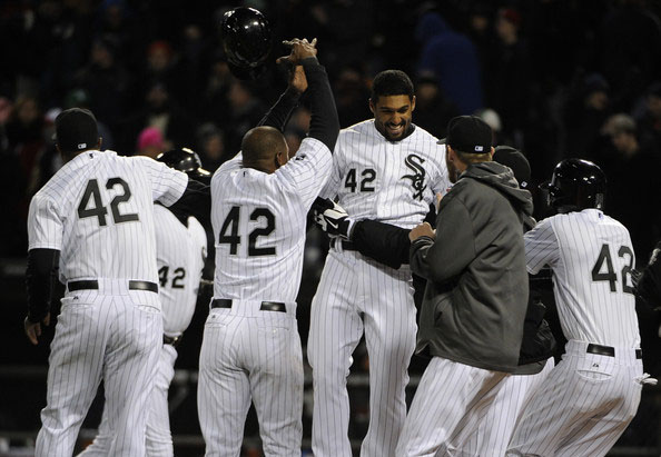 Marcus Semien (center) of the Chicago White Sox celebrates with his teammates after driving in the game winning run during the ninth inning against the Boston Red Sox on April 15, 2014 at U.S. Cellular Field in Chicago, Illinois.