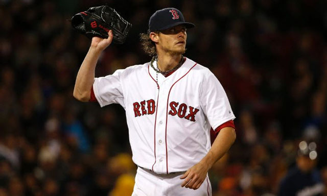 Boston Red Sox starting pitcher Clay Buchholz leaves the mound after giving up three runs to the Milwaukee Brewers during the third inning of a baseball game at Fenway Park in Boston, Saturday, April 5, 2014. 