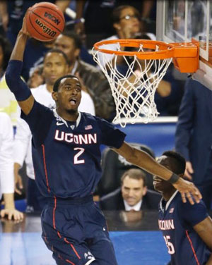 Connecticut forward DeAndre Daniels dunks the ball during the second half of the NCAA Final Four tournament college basketball semifinal game against Florida Saturday, April 5, 2014, in Arlington, Texas.