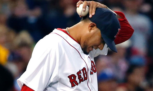 Boston Red Sox starting pitcher Felix Doubront reacts on the mound after giving up runs to the Texas Rangers in the third inning of a baseball game at Fenway Park in Boston, Tuesday, April 8, 2014.