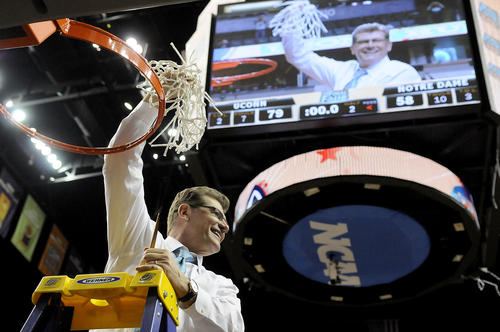  Connecticut Huskies head coach Geno Auriemma raises the net after UConn defeated Notre Dame for the 2014 NCAA Women's National Championship in Nashville, TN., Tuesday night at the Bridgestone arena. 