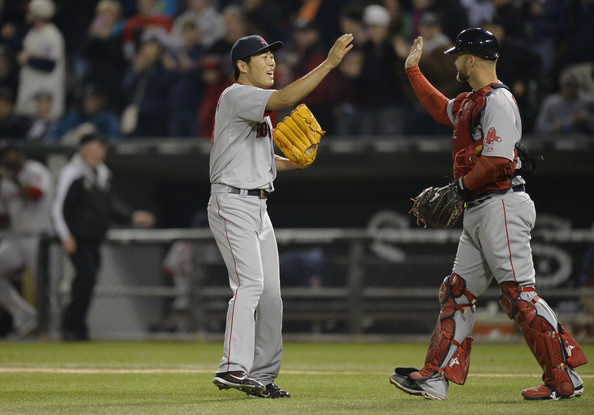 Relief pitcher Koji Uehara #19 (L) and catcher David Ross #3 of the Boston Red Sox celebrate their win over the Chicago White Sox at U.S. Cellular Field on April 17, 2014 in Chicago, Illinois. 