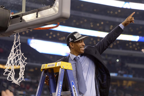  UConn coach Kevin Ollie celebrates after the win and before cutting down the net. 