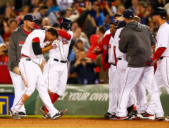  Xander Bogaerts #2 of the Boston Red Sox is mobbed by his teammates including Brock Holt #26 after hitting the walk-off game-winning single in the 9th inning against the Atlanta Braves during the game at Fenway Park on May 29, 2014 in Boston, Massachusetts. 