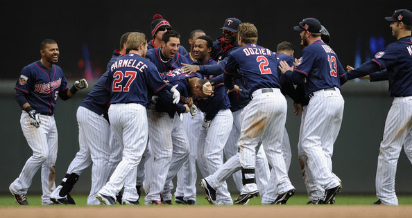 The Minnesota Twins celebrate a walk-off single against the Boston Red Sox by Aaron Hicks #32 during the tenth inning of the game on May 15, 2014 at Target Field in Minneapolis, Minnesota.
