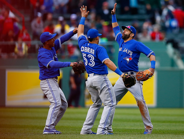  Jose Bautista #19, Melky Cabrera #53, and Anthony Gose #8 of the Toronto Blue Jays celebrate their win and sweep of the Boston Red Sox during the game at Fenway Park on May 22, 2014 in Boston, Massachusetts. 