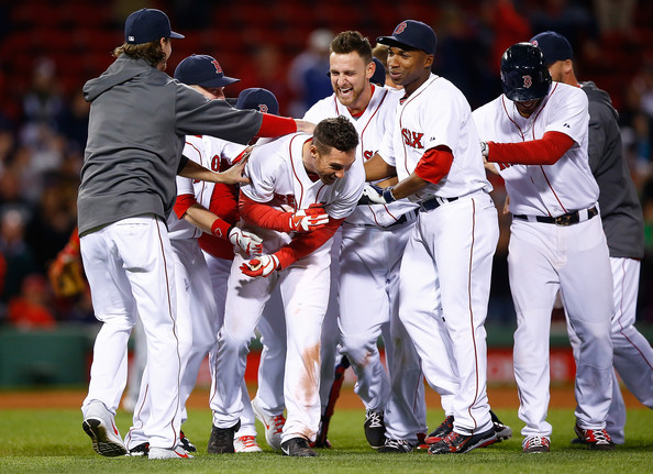  Grady Sizemore #38 of the Boston Red Sox is mobbed by teammates including Will Middlebrooks #16 and Jonathan Herrera ##10 after hitting his walk-off hit in the bottom of the 12th inning against the Cincinatti Reds during the interleague game at Fenway Park on May 6, 2014 in Boston, Massachusetts. 