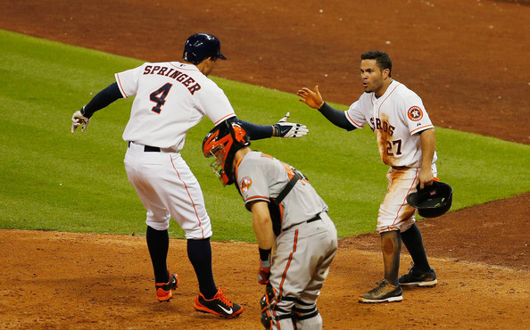  Jose Altuve #27 of the Houston Astros greets George Springer #4 at home plate after Springer hit a two-run home run in the seventh inning of their game against the Baltimore Orioles at Minute Maid Park on May 29, 2014 in Houston, Texas. 