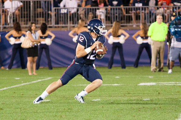 UConn QB Casey Cochran (12) drops back to pass in the second quarter on August 29, 2014 at Rentschler Field in East Hartford, CT