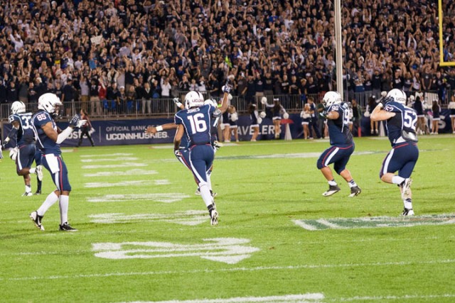 Byron Jones and the  UConn defense celebrate after stopping Devin Gardner (not pictured) on a 4th and 2 in the 4th quarter at Rentschler Field on September 21, 2013