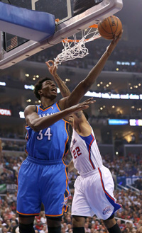 Hasheem Thabeet #34 of the Oklahoma City Thunder shoots over Matt Barnes #22 of the Los Angeles Clippers at Staples Center on November 13, 2013 in Los Angeles, California. 