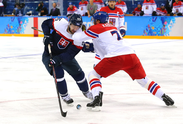  Peter Olvecky #85 of Slovakia handles the puck against Tomas Kaberle #7 of Czech Republic in the first period during the Men's Qualification Playoff Game on day 11 of the Sochi 2014 Winter Olympics at Shayba Arena on February 18, 2014 in Sochi, Russia. 