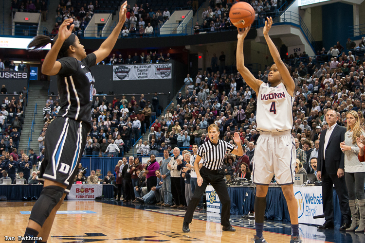 UConn G Moriah Jefferson (4) puts up a three-pointer over Duke G Ka'lia Johnson (14) to start the second half at the XL Center in Hartford, CT. Jefferson would make the three as part of her 18 points.