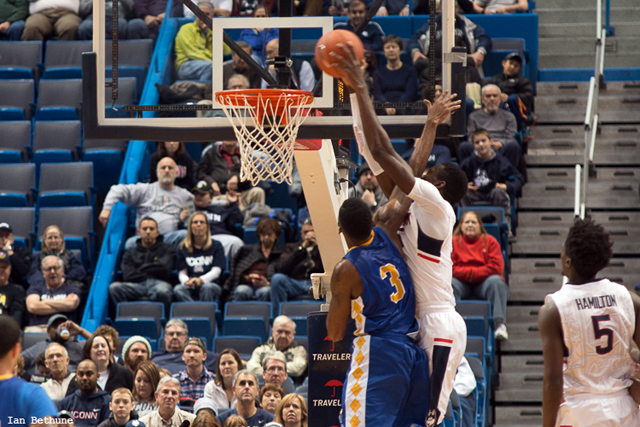 UConn C Amida Brimah (35) slams home an alley-oop pass from Daniel Hamilton (5) over Coppin State F Arnold Fripp in the second half at the XL Center on December 12, 2014.