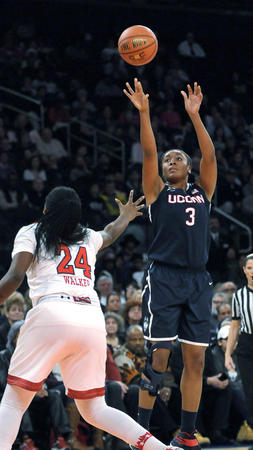 UConn forward Morgan Tuck fires for two of her game-high 23 points over St. John's forward Jade Walker in the first half.